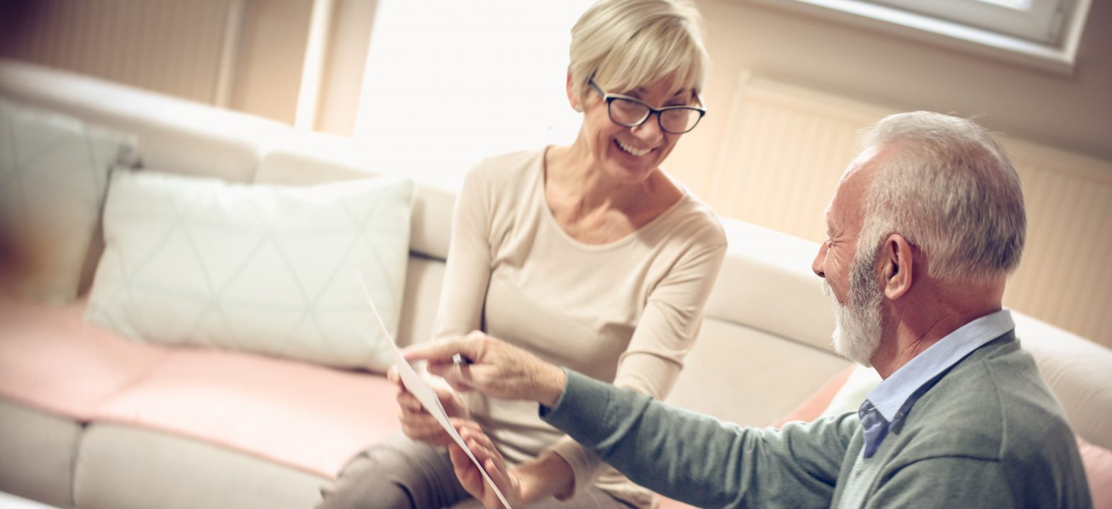 Senior male and female looking at documents together