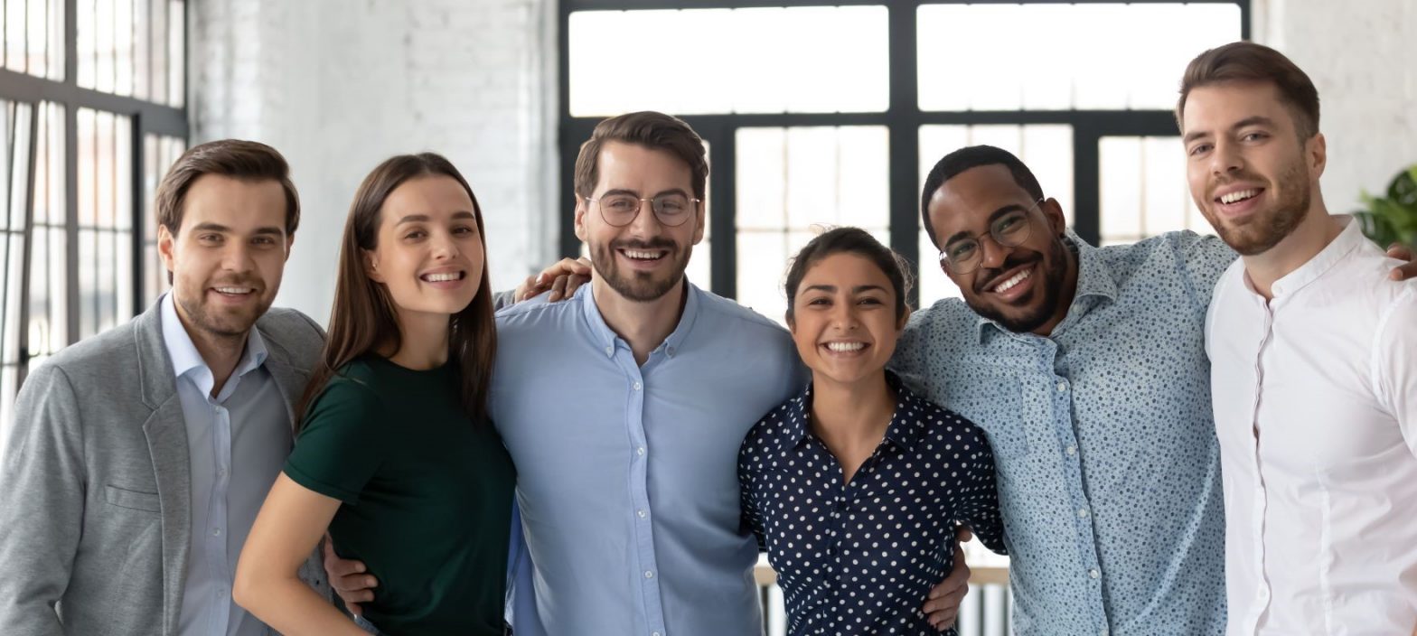 A group of young professionals smiling at the camera