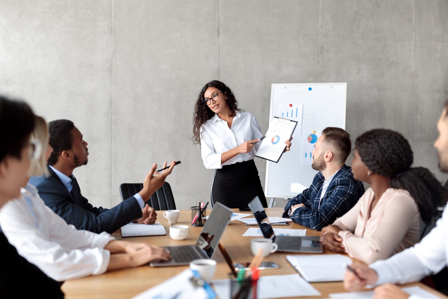 A mentor is presenting information to a group of colleagues.