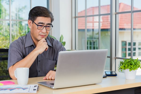 Businessman looking at information on his laptop.