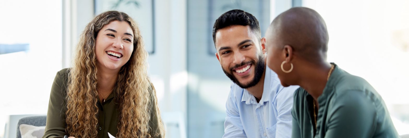 3 business people in discussion and smiling