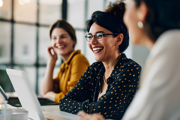 Smiling business women with laptops