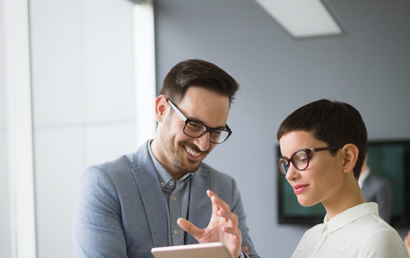 Male and female business colleagues collaborating and discussing plans.