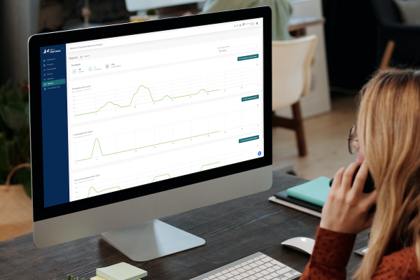 Woman looking at a computer screen with the Art of Mentoring software