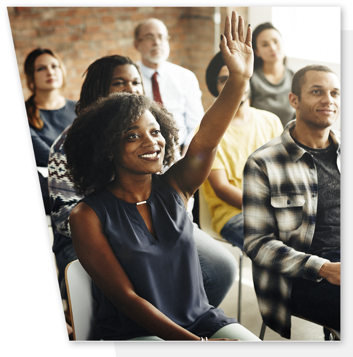 A woman has her hand raised in a mentoring workshop