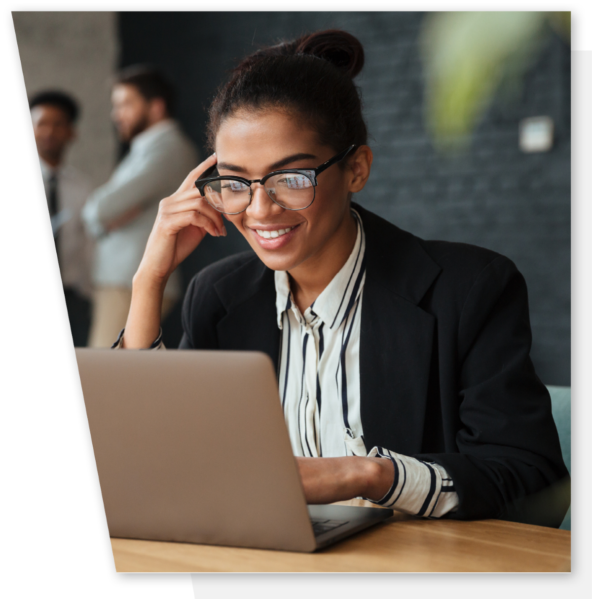 Female businesswoman wearing glasses and working on her laptop