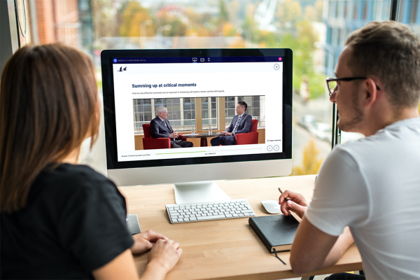 People are watching one of the Art of Mentoring workshop videos online together. The website is displayed on a desktop computer.